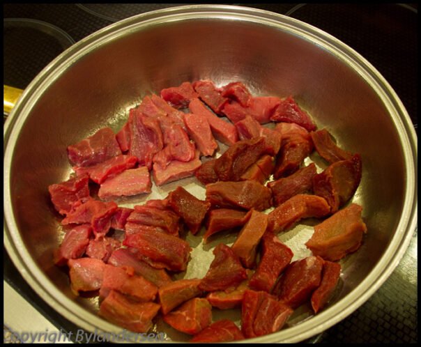 Place the meat in the bottom of a skillet. Start by arranging the meat in pan.