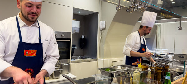Busy chefs cooking at the Seafront Pasta Bar in Naples, Italy.